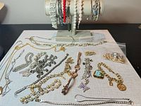 Overall view of jewellery lot on mat and bracelet stand