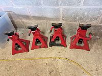 Four red jack stands side by side