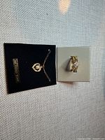 Ring and necklace on cards showing overall lot contents
