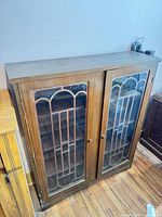 Front view of wooden bookcase with glass doors