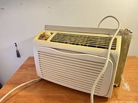 Front view of Kenmore window air conditioner showing grille, controls and power cord