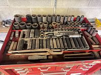 Drawer full of assorted sockets, extension and pliers
