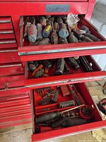 Two drawers of red Husky tool chest showing various screwdrivers and bit sets