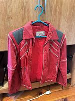 Front view of red zippered jacket on hanger