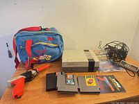 Overview of NES console, travel bag, Zapper, controller, game cartridges and cables