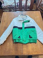 Front view of Quaker State Racing jacket laid flat showing color blocking and overall condition