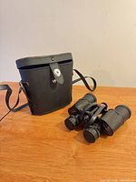 Binoculars beside fitted case