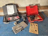 Overall lot layout showing soldering guns, Pop nut kit, solder spool, organizer, instructions