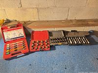 All four plastic cases open showing contents