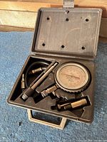 Full kit inside open carry case on blue surface