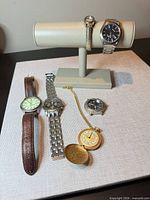Six watches laid out on fabric, showing overall lot