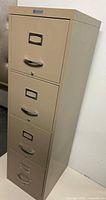 Full view of tan 4-drawer filing cabinet