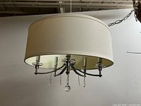 Full view of chandelier showing drum shade and crystal drops