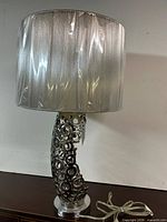 Full lamp showing shade, openwork body and cord