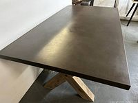 Overall view of concrete top and part of wooden base