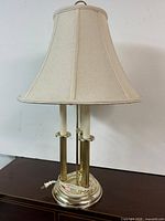 Full view of brass-tone lamp with shade