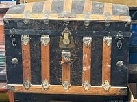 Front view of dome top trunk showing slats and hardware