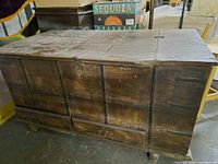 Full view of wooden chest front with drawers and latch
