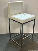 Full view of counter stool showing seat, back and metal base
