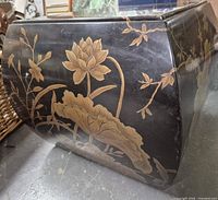 Side view showing hand painted gold lotus and floral motifs on black lacquer surface