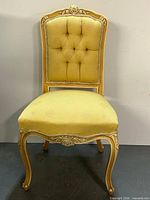 Front view of carved Louis XV style side chair with yellow jacquard upholstery