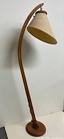 Full view of teak arc floor lamp showing entire height and base