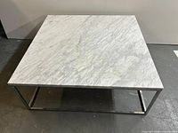 Top view of square marble coffee table showing full surface and base