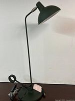 Full view of Natuzzi metal table lamp showing height, stem, shade and base