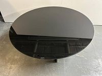 Top view of round black glass coffee table