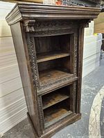 Full view of carved wood bookshelf front and side
