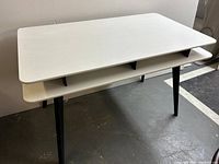 Full top view of desk showing two-tier design and tapered legs