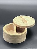 Box open showing two compartments and spoon on lid