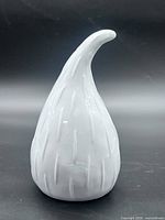 Front view of white glazed ceramic gourd with curved stem and textured surface