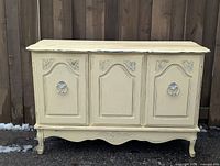 Front view of three-door cream buffet cabinet
