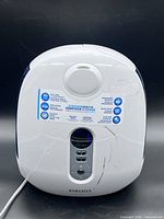 Front view showing Homedics branding, control panel, scratches