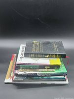 Stack of ten books showing variety of sizes and bindings