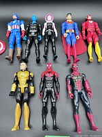 Group shot of all eight 12-inch superhero figures laid flat