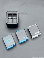 Charger and three batteries laid out