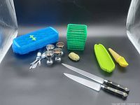 Full lot overview showing knives, ice cube tray, egg cups, spoons, corn tray, scoop, brush