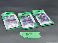 Three blister-packed hockey card packs on black background