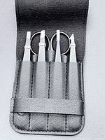 Open pouch displaying three tweezers and scissors