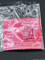 Sealed pin on backing card in plastic