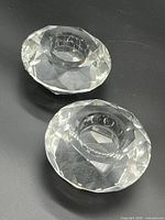 Two faceted clear glass tealight holders top view, showing recessed candle area