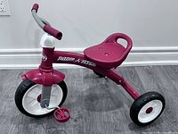 Full side view of pink Radio Flyer tricycle