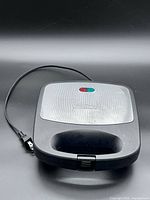 Closed Salton press showing exterior and power cord