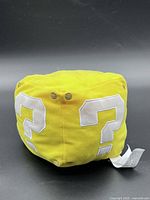 Front/top view of yellow Question Block plush