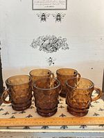 Front view of five amber diamond quilted mugs