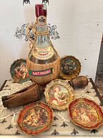 Full view of straw-wrapped Antinori bottle, six coasters arranged, wooden corker front