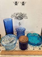 Group shot of all five blue glass pieces with ruler for scale