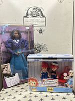 Front view of both boxed dolls